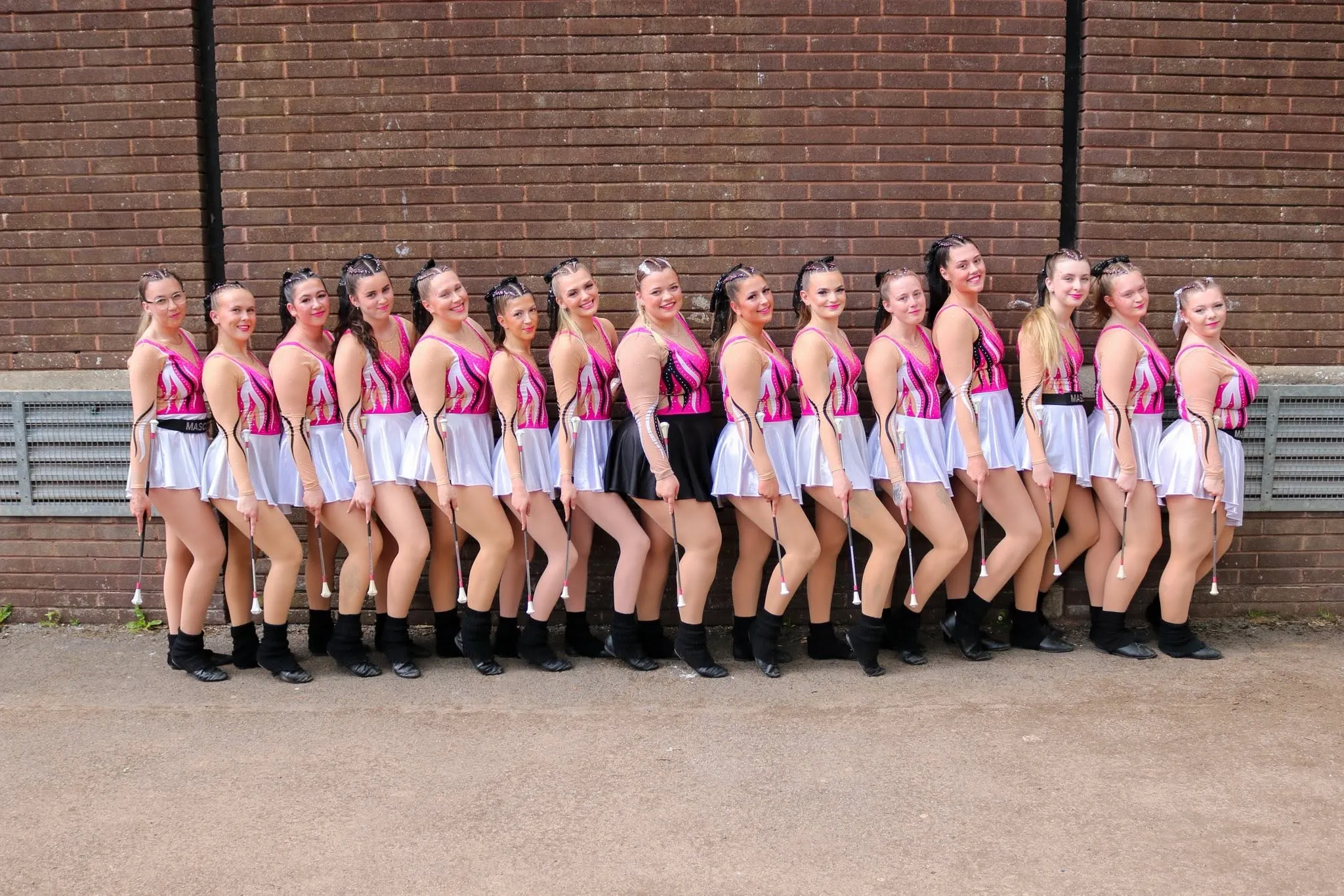 Diamond Twirlers senior squad in their pink and white majorette costumes